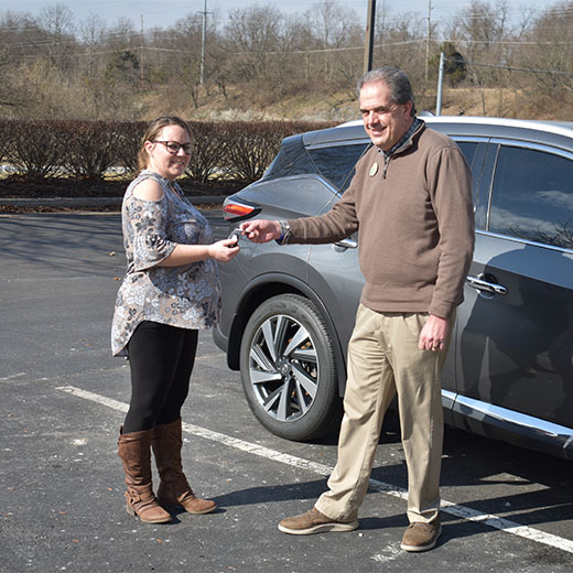 Expree loan office handing keys to new car owner