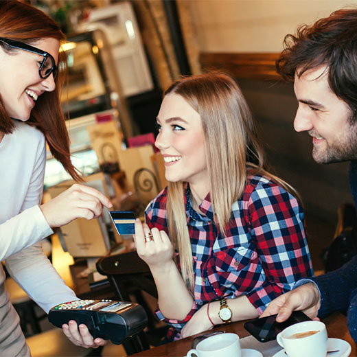 Young woman paying with a credit card