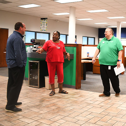 Expree employees talking with a member in the lobby