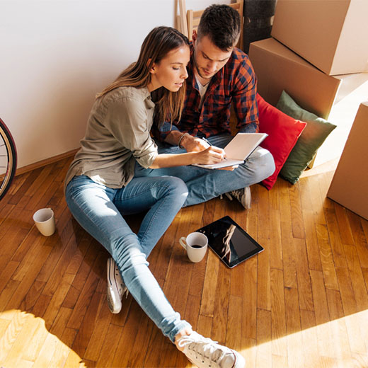 Young couple planning in their new home