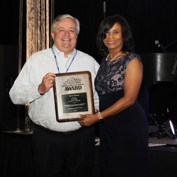 Expree Board Chair Paul Royce accepts Expree's Dora Maxwell Award.