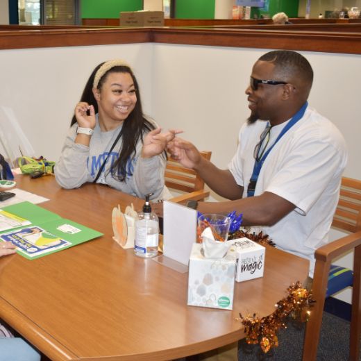 Male member of Expree Credit Union referring a female friend to open an account.
