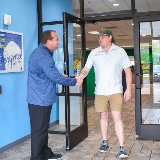 Expree Loan officer and business employee shake hands