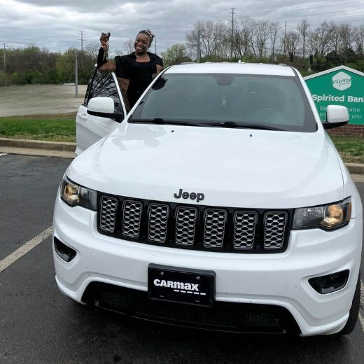 Expree Credit Union member shows off keys to her new car.