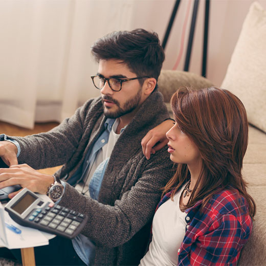 Couple sitting on floor working on finances