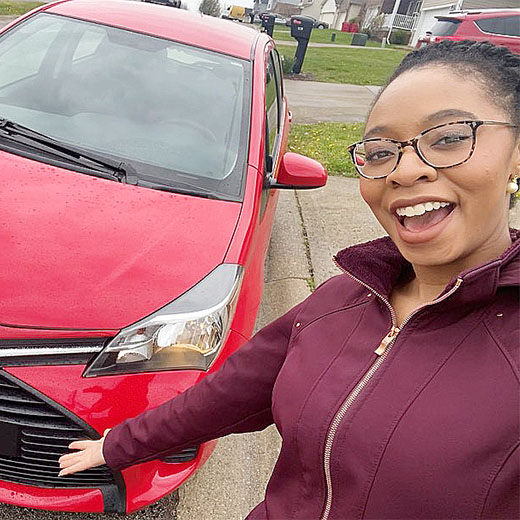 Happy woman with her new car